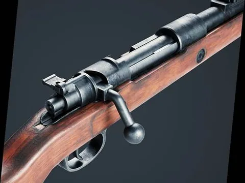 Close detail of a bolt-action rifle receiver, bolt handle and walnut stock