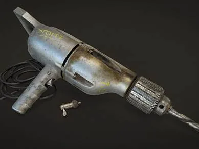 A worn hand-held electric drill in cast aluminium with a chuck key on its cable